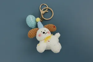 Detailed view of handmade crochet puppy keychain, cute yarn woven plush bag charm accessory.