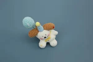 Handmade crochet puppy plush charm with balloon detail, soft yarn pendant accessory.