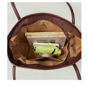 Vue intérieure de sac cabas vintage marron, grand sac porté épaule avec poches pratiques.