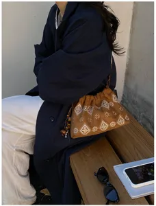 Retro brown suede shoulder bag with boho embroidery and cute wooden bead charms for women.