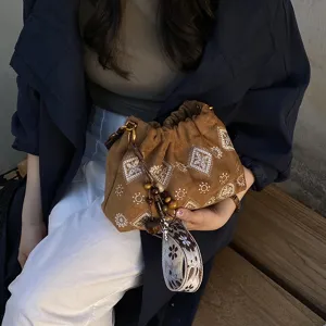 Retro brown suede drawstring shoulder bag with exquisite white embroidery and beaded strap.