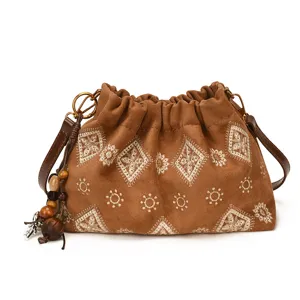 Vintage brown suede embroidered shoulder bag with wooden beads for casual daily use.