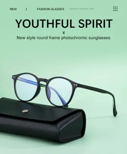 Detailed view of men's round frame photochromic sunglasses resting on a black leather case.