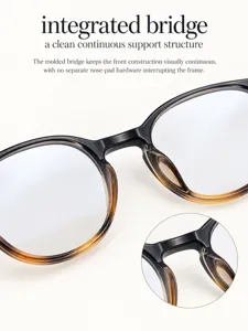 Close up view of stylish oval sunglasses featuring an integrated bridge design for clean look.