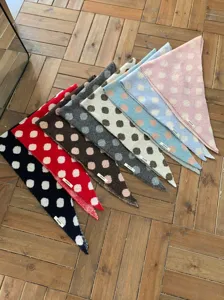 Knitted polka dot triangular scarf detail, multi-color warm winter fashion accessory design.