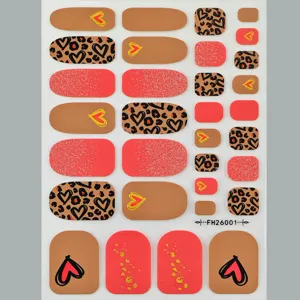 Détail d'autocollant d'ongles avec motif léopard et cœur pailleté pour le style estival.