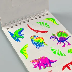 Vue détaillée d'un carnet d'autocollants de tatouage dinosaure lumineux avec de jolis motifs.