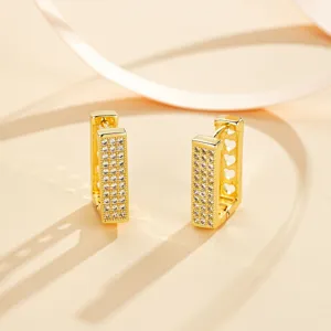 Gold geometric rectangle pavé cubic zirconia hoop earrings with delicate hollow heart side details.