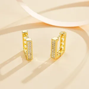 Detail view of luxury gold-plated geometric rectangle hoop earrings with sparkling cubic zirconia.