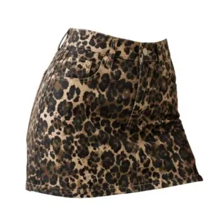Leopard print denim mini skirt detail, stylish high waist A-line hip hugging apparel.