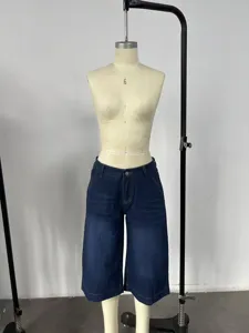 Detailed shot of dark blue low-waist casual loose straight wash denim capri pants.
