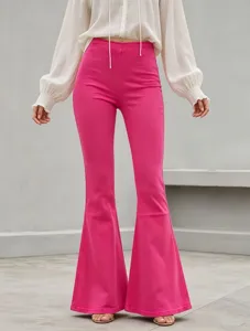 Close-up detail of high-waisted stretchy hot pink flare trousers showing slim fit silhouette.