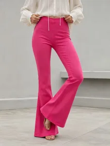 Detail view of women's bright pink high-waisted stretch flare denim trousers close up.