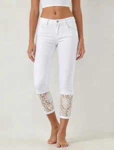 Women's white cropped denim jeans featuring stylish lace cuffs and stretch fit design.