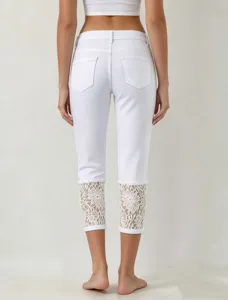Women's white cropped denim jeans featuring delicate lace cuffs, perfect for casual summer wear.