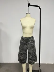Detail shot of women's camouflage denim cargo capri pants on a mannequin, casual style.