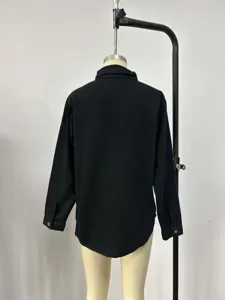 Detailed back view of a casual black long-sleeved denim jacket for women, lapel style.