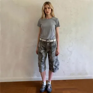 Loose casual camouflage sport cargo low-waist women capris with grey tee outfit detail.