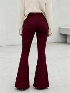 Back view details of women's high-waisted solid burgundy flare trousers and slim fit design.