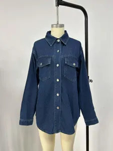 Close up view of the dark blue denim jacket detailing long sleeves and metal buttons.