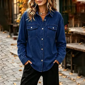 Close-up detail of women's dark blue denim shirt jacket with metal buttons and chest pockets.