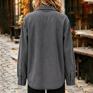 Detail view of dark grey washed denim jacket back, long sleeve button up.
