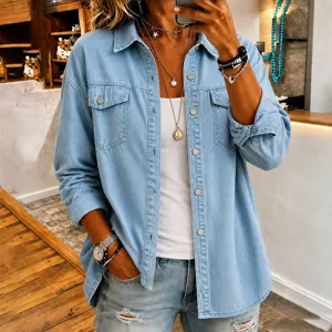 Casual light blue denim long sleeve button-up shirt jacket for women, detailed styling.