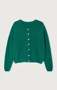 Green knit cardigan detail showing V-neckline and white button closure, soft sweater texture.