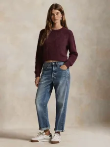 Wine red cropped crewneck knit sweater with high waist blue jeans, stylish autumn outfit.