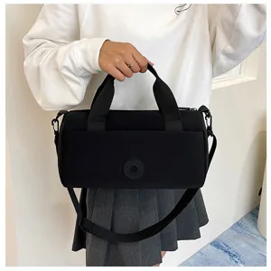 Sac bandoulière cylindrique noir décontracté, sac à main de voyage élégant avec poignée.