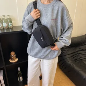 Casual black crossbody bag for women, lightweight nylon sling bag for daily travel and outdoor sports.