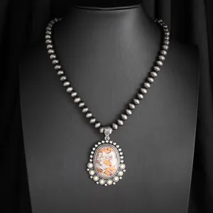 Vintage boho style beaded necklace with statement stone pendant, western cowboy jewelry piece.