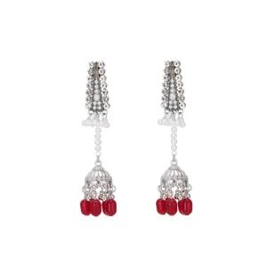 Detailed view of silver rhinestone long jhumka earrings with pearls and red beads.
