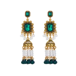 Detailed close-up of vintage gold green gemstone pearl jhumka drop earrings, ethnic style.