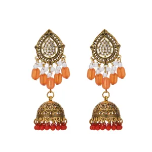 Vintage ethnic gold teardrop jhumka earrings with pearls, crystals and orange tassels.