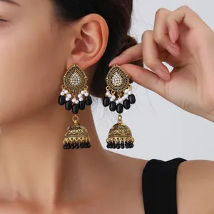 Vintage ethnic gold-tone teardrop jhumka earrings with black beads and white pearls for women.