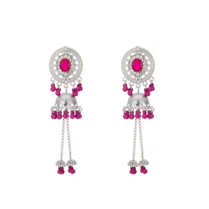 Detailed close-up of ethnic style silver jhumka earrings with pink beads and stone.