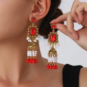 Vintage ethnic gold-tone red crystal pearl jhumka earrings long tassel drop jewelry detail shot
