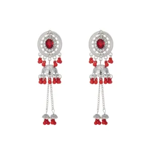 Detailed close-up showing the intricate hollow disk, sparkling rhinestones, and red bead charms.