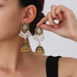 Vintage ethnic antique gold teardrop jhumka earrings with pearls and white crystals.