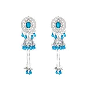 Detailed shot of ethnic style silver jhumka earrings with blue beads and crystal rhinestones.