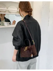 Stylish brown suede crossbody shoulder bag for women, niche design retro commuting bucket bag.