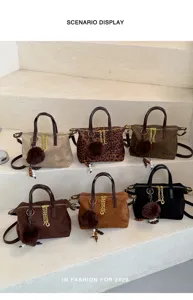 Stylish suede shoulder handbag with metallic chain and cute pom-pom charm for women autumn.