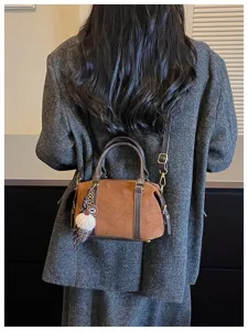 Detailed view of the vintage brown suede crossbody bag showcasing its unique charm and texture.