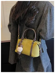 Retro niche design suede shoulder bag for women, stylish crossbody bag with cute charm.