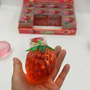 Close-up detail of the translucent red strawberry squeeze toy showing soft texture.
