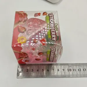 Transparent crystal strawberry squishy toy detail view with packaging and size reference ruler.