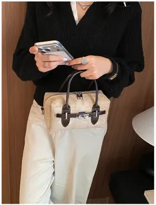 Retro style pillow handbag with dark brown handles and structured lock design for women.