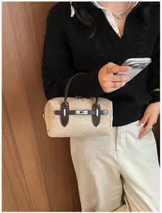Detailed view of Korean style vintage suede pillow bag with chic turn-lock closure design.