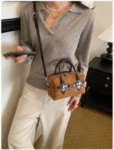 Detailed view of the Korean style retro brown suede crossbody pillow bag with metal lock.